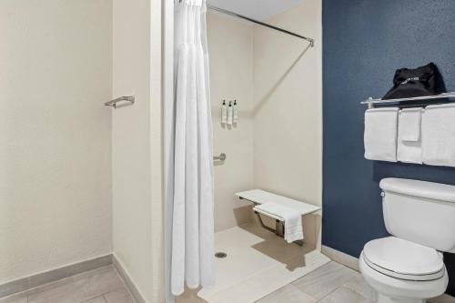 a bathroom with a toilet and a shower at Fairfield Inn & Suites By Marriott Hinesville Fort Stewart in Hinesville