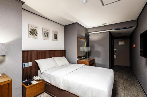 a hotel room with a bed and a television at Insadong Crown Hotel in Seoul