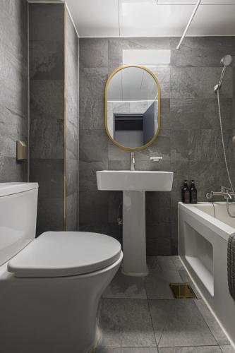 a bathroom with a toilet and a sink and a mirror at Insadong Crown Hotel in Seoul