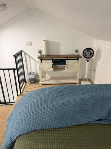 a bedroom with a bed and a dresser at Cozy Creek Retreat in Waterford