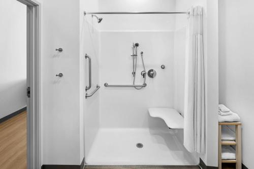 a bathroom with a shower with a glass door at StudioRes by Marriott LaGrange in La Grange