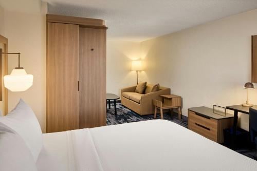 a hotel room with a bed and a couch at Fairfield Inn & Suites Cleveland Avon in Avon