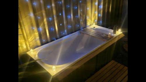 a large bath tub with lights on top of it at Cameo B&B in Matamata