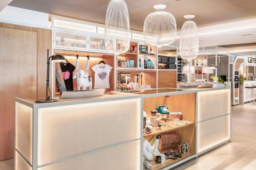 a store with a counter with a lot of products at INNSiDE by Meliá Zaragoza in Zaragoza