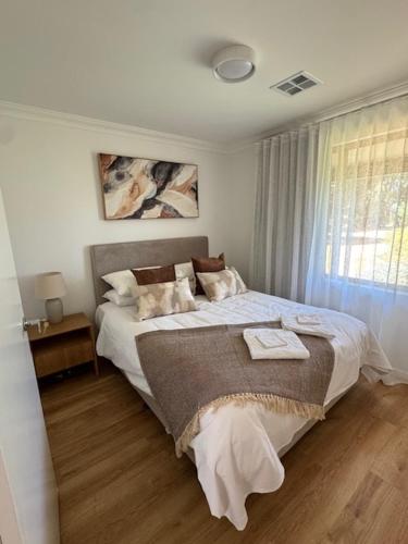 a bedroom with a large bed and a window at Sittella's Vineyard Residence in Herne Hill