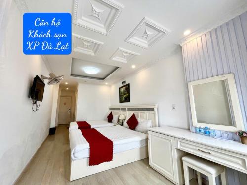 a bedroom with a bed and a sink and a mirror at Khách Sạn Căn Hộ XP -Đà Lạt in Da Lat