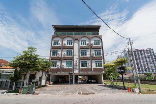 a tall building with a lot of windows at Swing & Pillows - Klebang, Melaka in Malacca