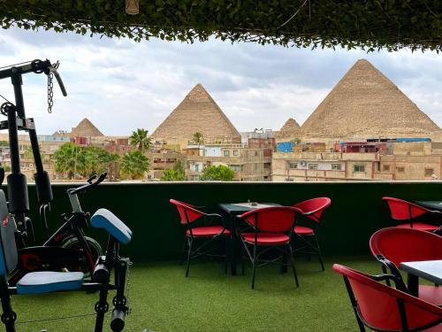 a table and chairs with a view of pyramids at Master kings of the pyramids and Sphinx in Cairo