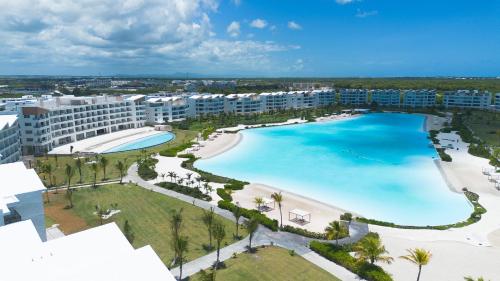 an aerial view of a resort with a large pool at The Palms Boutique Hotel & Residence in Punta Cana