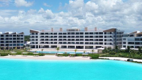 a large hotel with a large pool in front of it at The Palms Boutique Hotel & Residence in Punta Cana