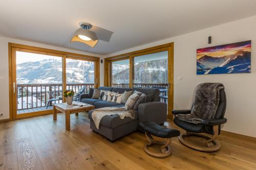 a living room with a couch and two chairs at Chalet Les Rahâs by Mrs Miggins in Grimentz
