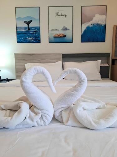 two swans made out of towels on a bed at Sunday House - Fisherman Village Samui in Bophut