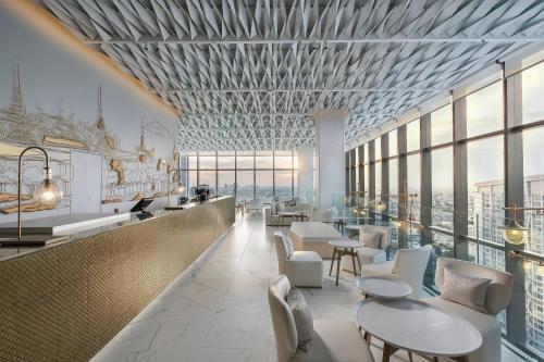 a rendering of a restaurant with tables and chairs at INNSiDE by Meliá Bangkok Sukhumvit in Bangkok