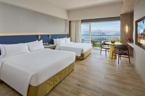 Krevet ili kreveti u jedinici u okviru objekta Taal Vista Hotel