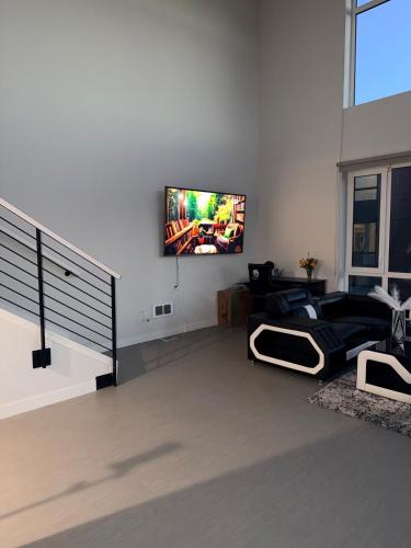 a living room with a flat screen tv on a wall at Moonlit Serenity 2 in Oakland
