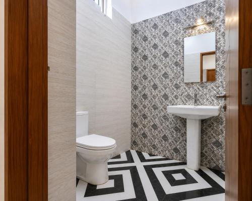 a bathroom with a toilet and a sink at Palam Villa in Kharar