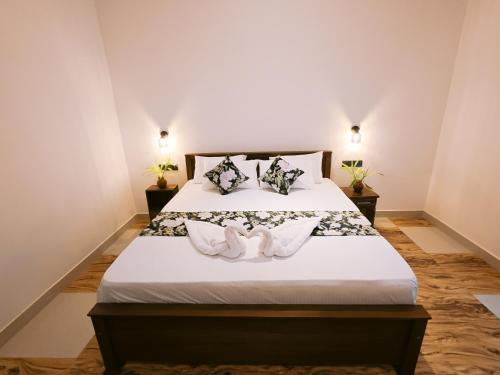 a bedroom with a bed with two swans on it at Lavera hideout in Dickwella