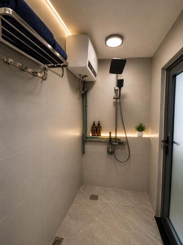a small room with a bed and a fan at Solwind Riverside in Danang