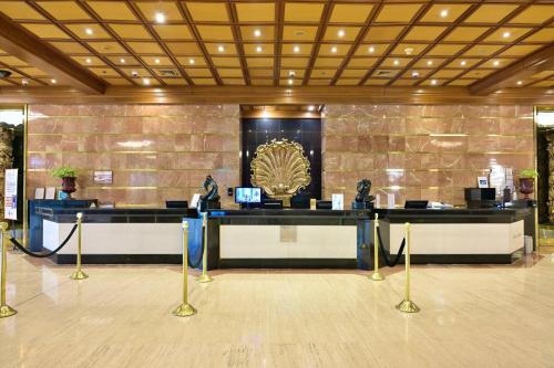a lobby with a desk with statues on it at Meliá Caracas in Caracas