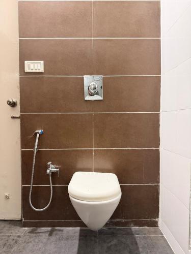 a bathroom with a toilet and a shower at The Saanj Villa in Sānand