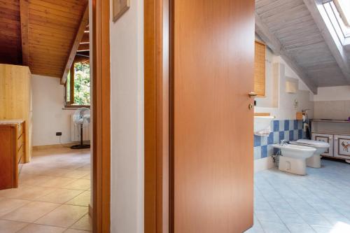 a bathroom with a sink and a toilet in a room at Maison Adriano Lago Maggiore in Sangiano