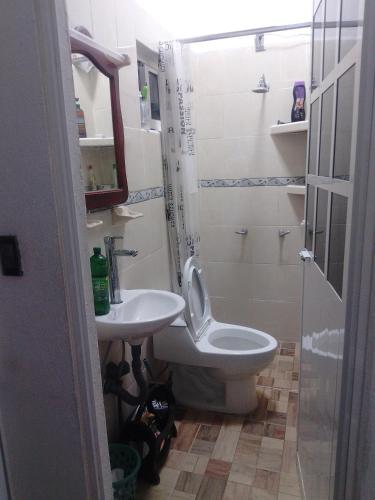 a bathroom with a toilet and a sink at Oscar in Poza Rica de Hidalgo