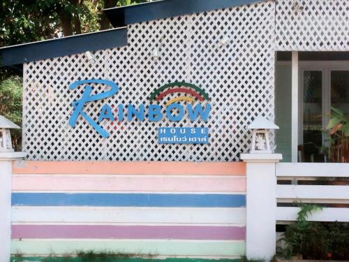 a building with a sign on the side of it at Rainbow House Resort in Kamphaeng Phet