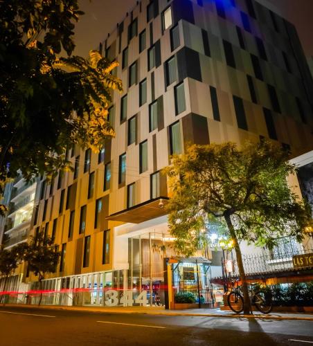 a building with a tree in front of it at INNSiDE by Meliá Lima Miraflores in Lima