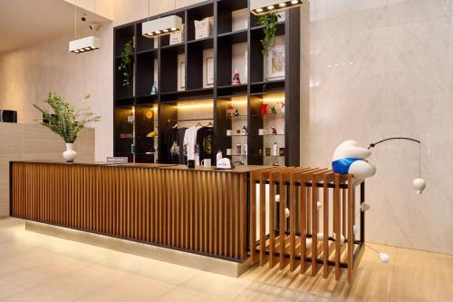a store lobby with a counter and a lamp at INNSiDE by Meliá Lima Miraflores in Lima