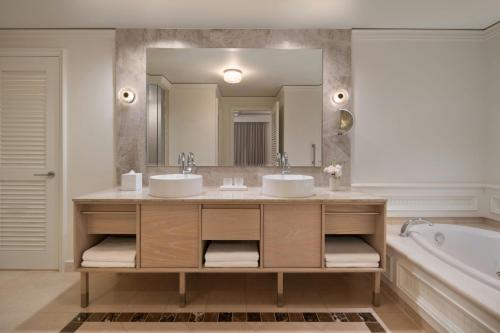 a bathroom with two sinks and a large mirror at The Ritz-Carlton Key Biscayne, Miami in Miami