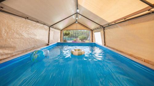 an indoor swimming pool with a tent at Daebudo Freesia Private Pool Villa in Ansan