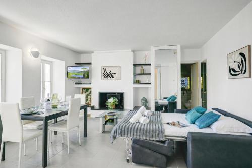 a living room with a couch and a dining room at Charm Apartments Aldesago in Aldesago