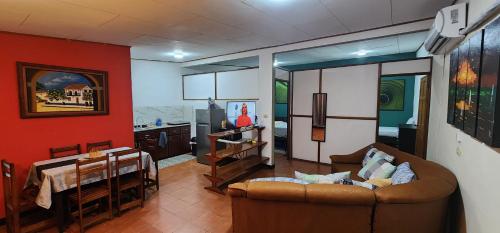 a living room with a couch and a table at Comfortable fully equipped apartment just 6 kilometers from Manuel Antonio, with parking and fast WiFi in Quepos