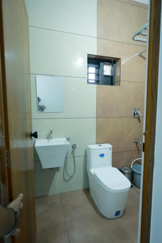 a bathroom with a toilet and a sink at Nirmalyam Homestay in Kuttippuram