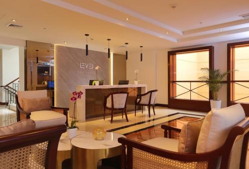 a living room with tables and chairs and a kitchen at Meliá Lima in Lima