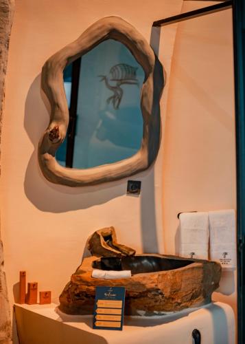 a bathroom with a mirror and a sink at Valahara Eco-Luxury Camp in Antsirabe