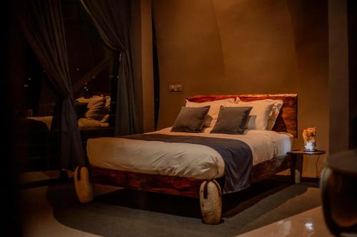 a bedroom with a bed in a room with a mirror at Valahara Eco-Luxury Camp in Antsirabe