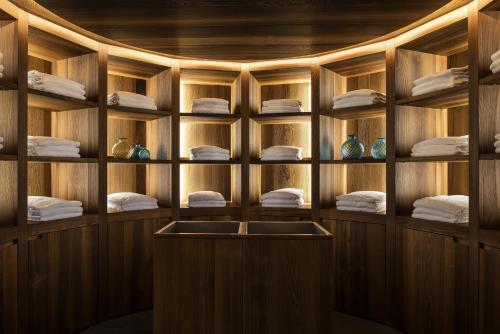 a room with wooden walls and shelves with towels at Hyatt Centric Milan Centrale in Milan