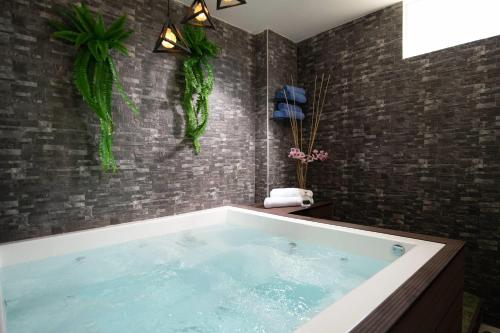 a large bath tub in a bathroom with brick walls at Casa Marina Sosua, Trademark by Wyndham All Inclusive in Sosúa