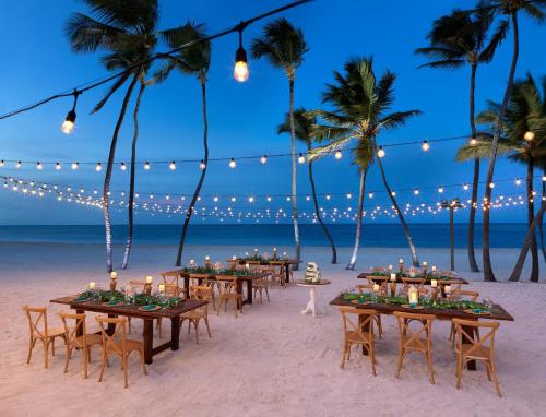 an outdoor dinner party on the beach at night at Meliá Caribe Beach Resort - All Inclusive in Punta Cana