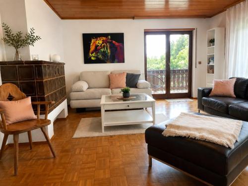 a living room with a couch and a table at Odw homes - Wohnung im Landhaus mit Garten in Trösel