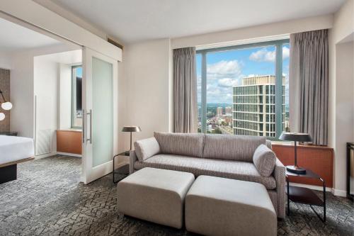 a living room with a couch and a large window at Sheraton Boston Hotel in Boston