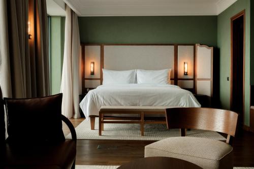 a bedroom with a bed and a table and chairs at BODBE Hotel in Sighnaghi