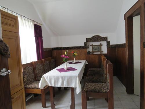 a dining room with a table and some chairs and a table and chairsktop at Rézkakas Fogadó in Zirc