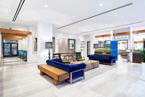 a lobby with blue couches and a table at INNSiDE by Meliá New York Nomad in New York