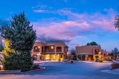 a house with a tree in a parking lot at Arroyo Pinion Hotel, an Ascend Collection Hotel in Sedona