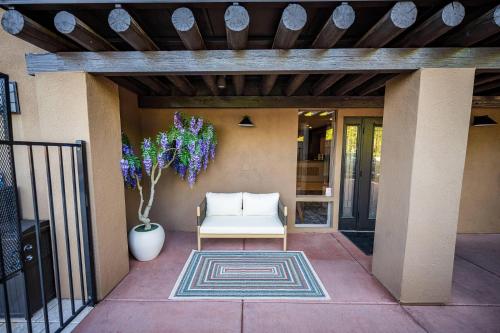 a porch with a white chair and a rug at Arroyo Pinion Hotel, an Ascend Collection Hotel in Sedona