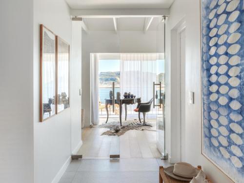 a hallway with a view of the ocean from a house at The Lighthouse in Simonʼs Town