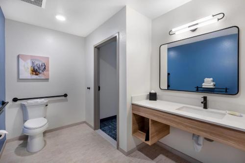 a bathroom with a white toilet and a sink at Sleep Inn & Suites Henderson - Las Vegas in Henderson