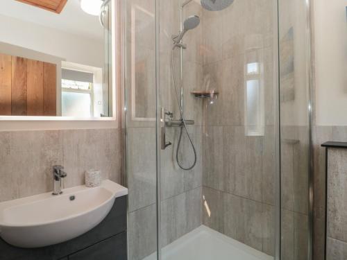 a bathroom with a shower and a sink at Sunnyside in Weston-super-Mare